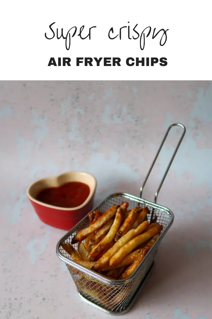 Air fryer fries in a basket with ketchup
