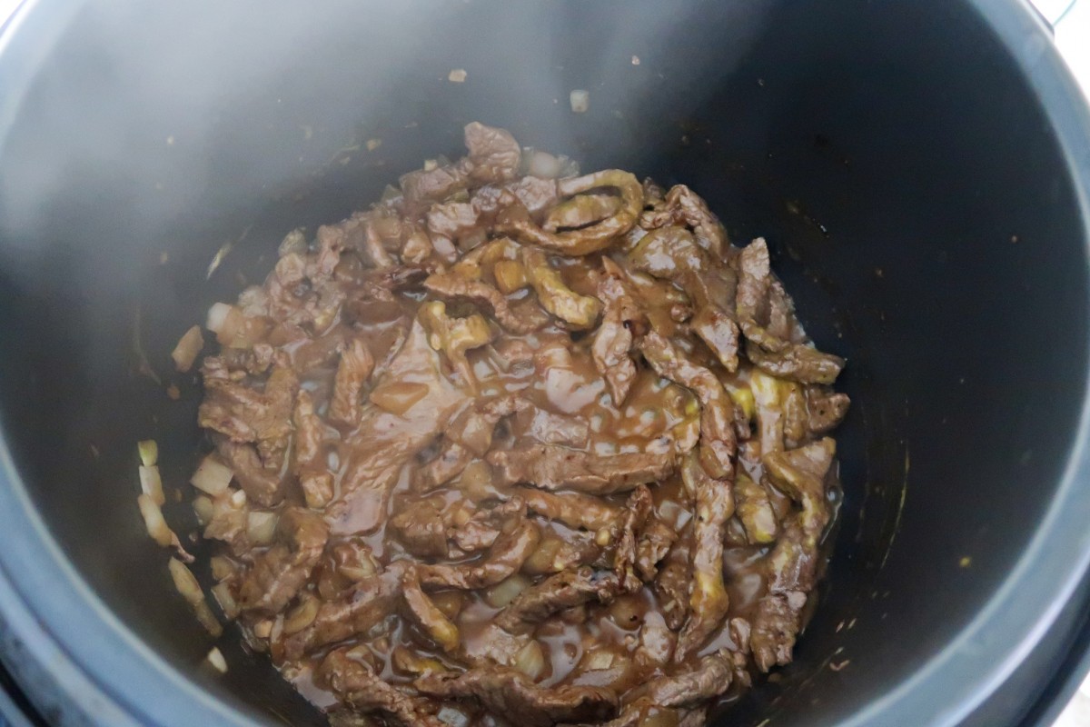 Slow cooker beef stroganoff - browned beef and onions with stock