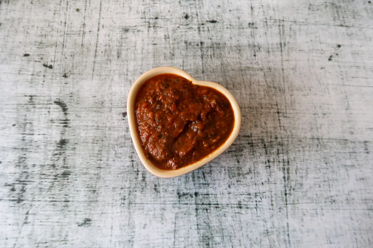 Kale tomato pasta sauce in a heart shaped ramekin