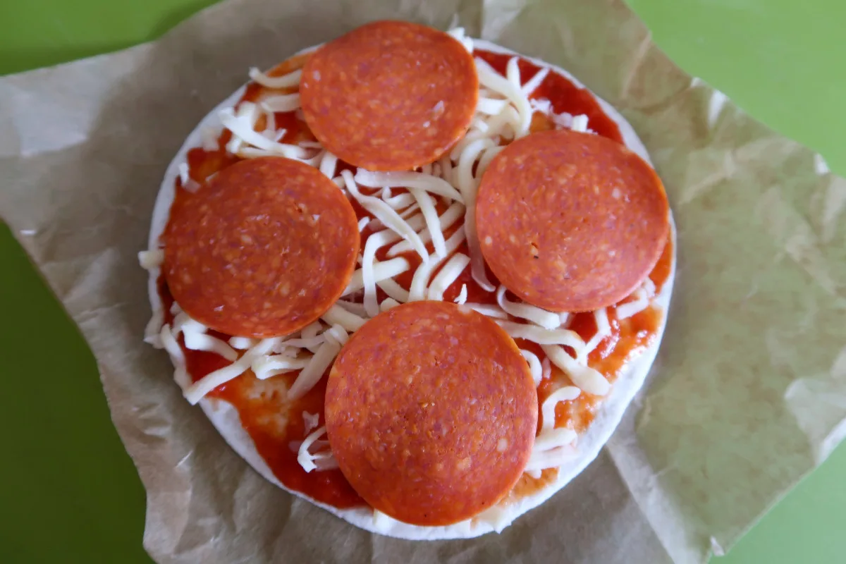 An air fryer tortilla pizza before cooking