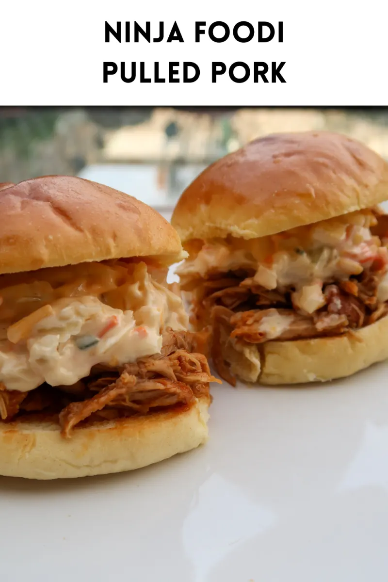 Two brioche buns filled with BBQ Ninja Foodi pulled pork and coleslaw